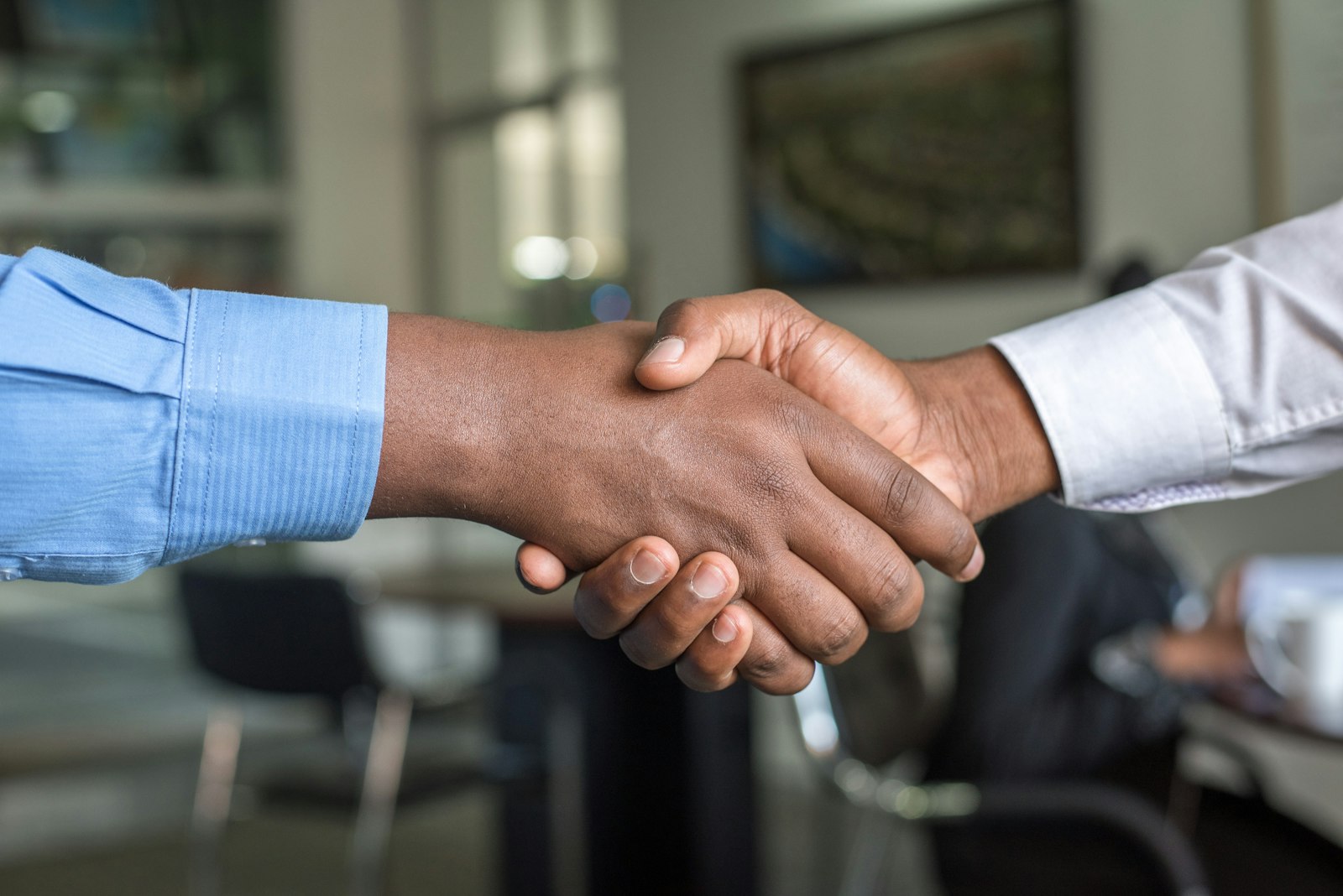 Intern receiving a job offer handshake